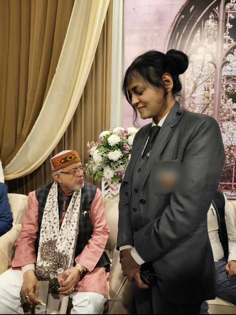 Vrinda Caterers staff attending to a guest at a corporate event